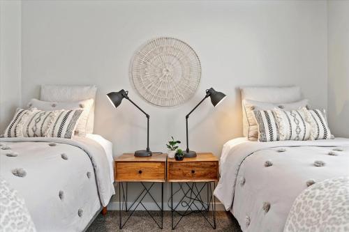 a bedroom with two beds and a table with a fan at Mineral Soak Rockers Fire Pit Game Room Fun in Meridian