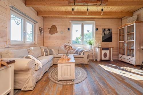 a living room with a couch and a table at Pod Żurawiem Urokliwy domek na Kaszubach in Michalin