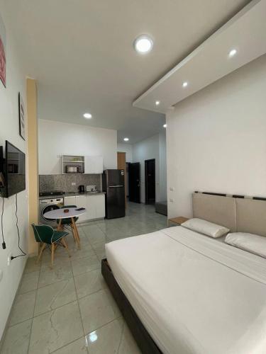 a bedroom with a large bed and a kitchen at Jasmine Resort & Aqua park in Sharm El Sheikh