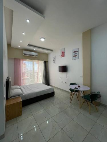 a bedroom with a bed and a table and a tv at Jasmine Resort & Aqua park in Sharm El Sheikh