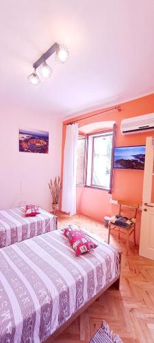 a bedroom with two beds and a window at Dignano in Vodnjan
