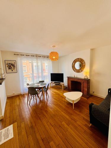 a living room with a couch and a table at Honoriane - Appartements meublés in Gien