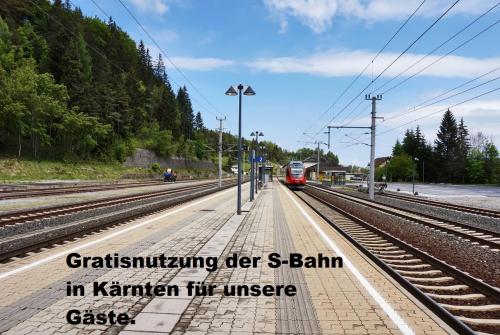 a red train on the tracks with the words christimining de s balain at Ferienwohnung Rosenbach in Rosenbach