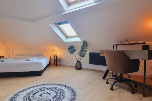 a bedroom with a bed and a desk and a piano at l'Atelier - Au pied des quais in Dunkerque