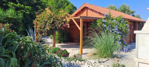 a garden with flowers in front of a house at Villa Soroni in Soroni
