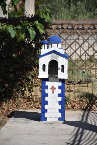 a blue and white bird house sitting on a sidewalk at Oceanides House in Lefkandi Chalkidas
