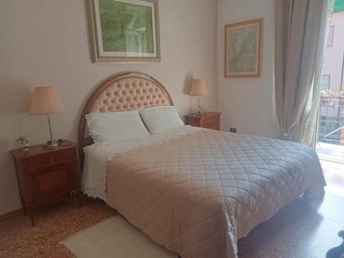 a bedroom with a bed and two night stands with lamps at La Casa di Paola in Graffignano