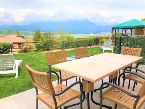 a table and chairs on a patio with a view at Residence Bellavista in Manerba del Garda