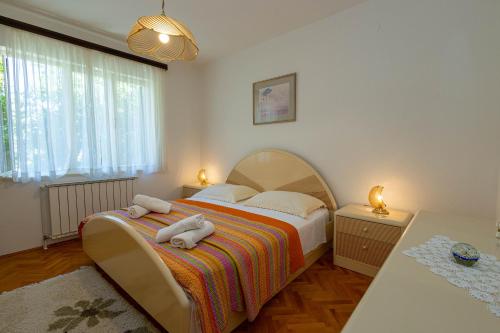 a bedroom with a bed with towels on it at Apartments ANIMA ex Marin in Podstrana