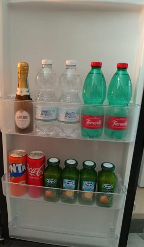 a refrigerator filled with lots of drinks and soda at La grotta in Procida