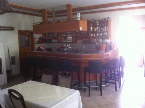 a bar in a restaurant with chairs around it at Waldhof in Villach