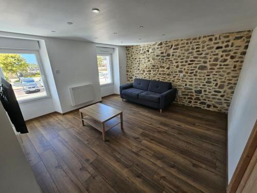 a living room with a couch and a coffee table at Appartement Cosy in Créances