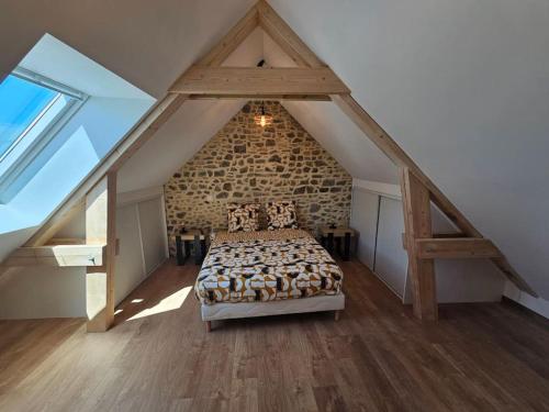 a bedroom with a large bed in an attic at Appartement Cosy in Créances