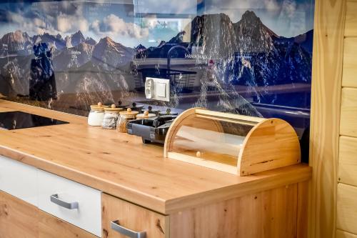 a kitchen counter with a view of a mountain at Magiczny Domek in Białka Tatrzanska