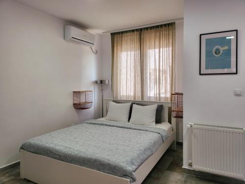 a bedroom with a bed and a window at OOTA Soko with Parking Garage in Kragujevac