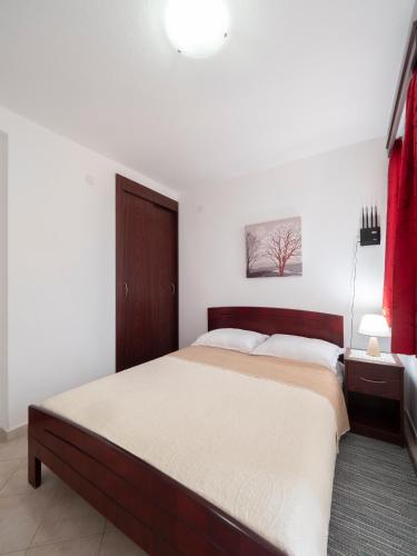 a bedroom with a large bed in a room at Apartments Marina in Sveti Stefan