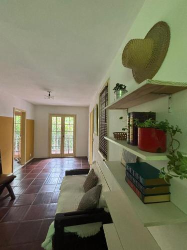 a living room with a couch and books on the wall at Flat Muqui 91 in Teresópolis