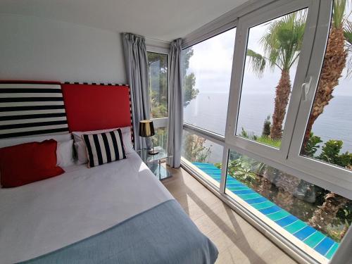 a bedroom with a bed and a large window at Condesa del Mar adults only in Altea