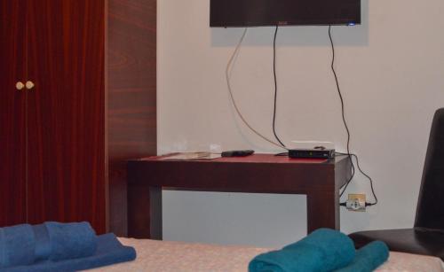 a room with a desk with a television on a wall at Villa Dulsinea in Ulcinj