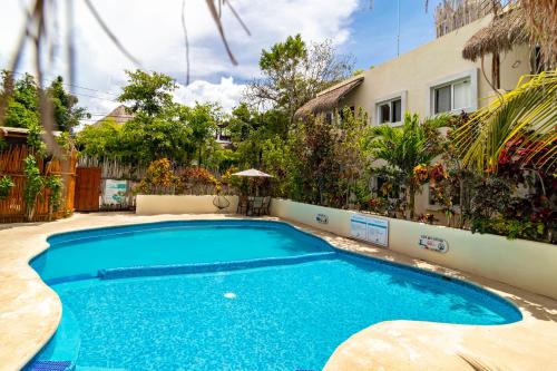 a large blue swimming pool next to a building at Hotel & Suites Oasis Bacalar in Bacalar