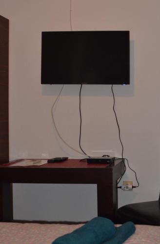 a flat screen tv sitting on a wooden table at Villa Dulsinea in Ulcinj