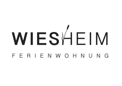 a logo for a furniture store at Ferienwohnung Wiesheim in Bad Hofgastein