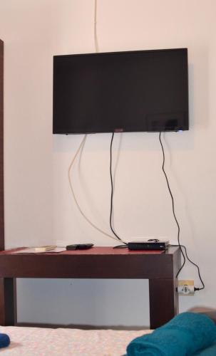 a flat screen tv hanging on a wall above a table at Villa Dulsinea in Ulcinj