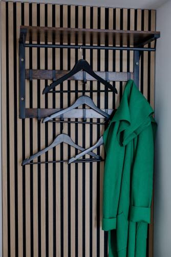 a green jacket is hanging on a shelf at UNiQE I 115qm I 3 Schlafzimmer I Nähe Messe in Haar