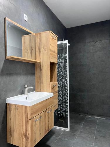 a bathroom with a sink and a shower at Royal Racing Suite Top 3 near Red Bull Ring in Judenburg