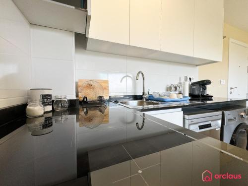 a kitchen with a sink and a counter top at Verano Azul in Cabanes