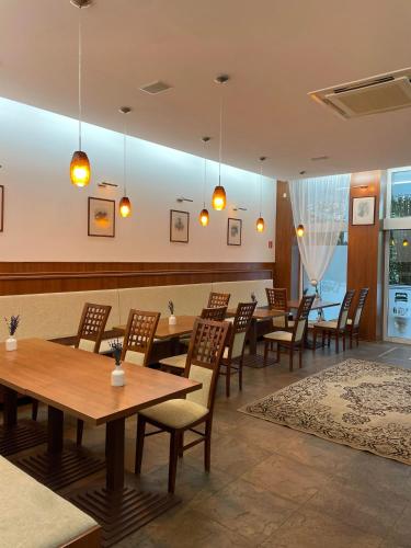 a dining room with wooden tables and chairs at Penzion Quercus in Dubové