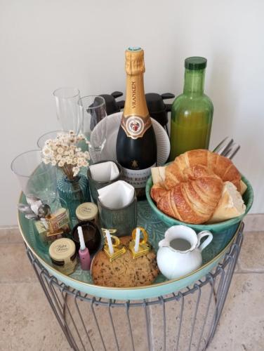a basket filled with bread and a bottle of wine at Chambre d'hôtes Chante Cigale in La Ciotat