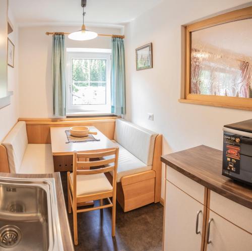 a small kitchen with a couch and a table at La Odles in Selva di Val Gardena