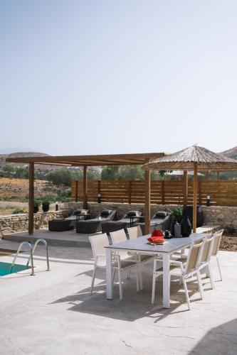 a white table and chairs on a patio at Kedros Katikies in Kalamaki Heraklion