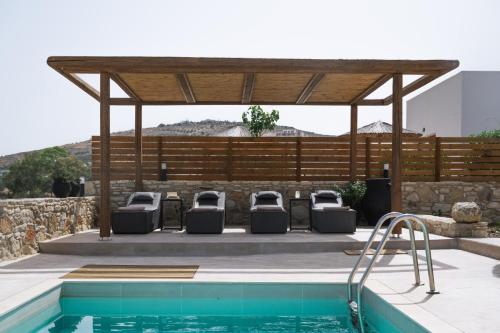 a gazebo with lounge chairs next to a pool at Kedros Katikies in Kalamaki Heraklion