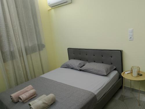 a small bedroom with a bed and a window at Black Eagle's Nest (studio) in Drama