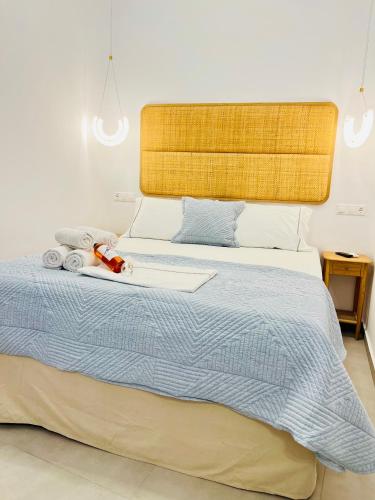 a bedroom with a large bed with a blue blanket at Gerani Deluxe Houses in Astypalaia Town