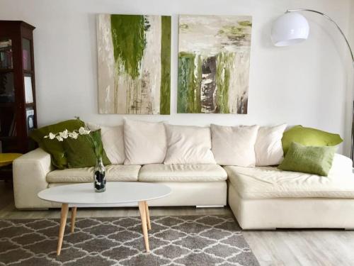 a living room with a white couch and a table at Jangilau - Large, triple aspect apartment in central Morzine in Morzine