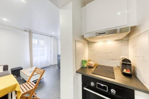 une cuisine avec un évier et un plan de travail dans l'établissement Cocon Urbain - Proche Paris, à Saint-Ouen