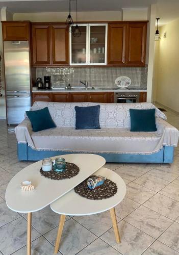 a living room with a couch and two tables at Luxury View in Iraklitsa