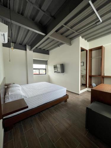 a bedroom with a bed and a wooden floor at TORRE YAX-CHE URBAN CENTER in Cancún