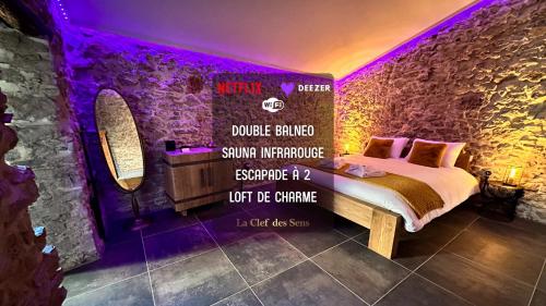 a bedroom with a bed with a purple lighting at Loft Romantique la Clef des Sens - Sauna et Balnéo privatifs in Tourves