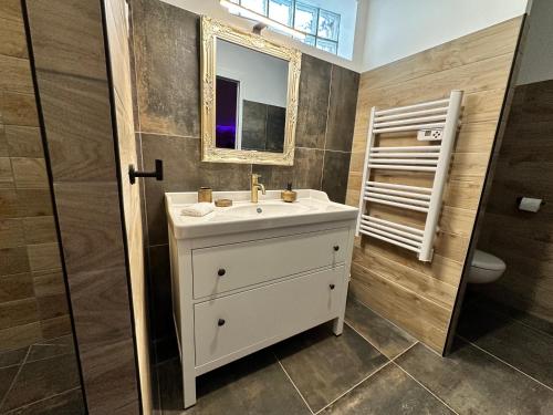 a bathroom with a white sink and a mirror at Loft Romantique la Clef des Sens - Sauna et Balnéo privatifs in Tourves