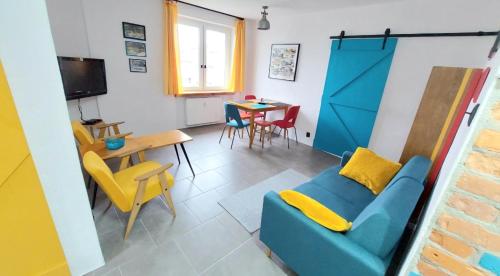 a living room with a blue couch and a table at Lovcik PRL in Głuchołazy