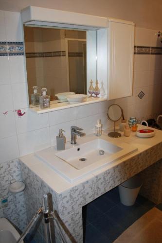 a bathroom with a sink and a mirror at La Casa di Paola in Graffignano