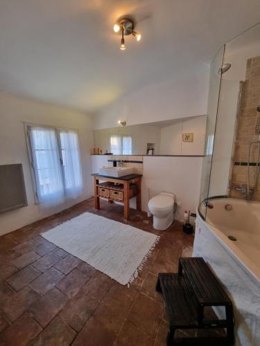 une salle de bain avec une baignoire, des toilettes et un lavabo dans l'établissement Belle chambre dans maison de charme, à Caunes-Minervois