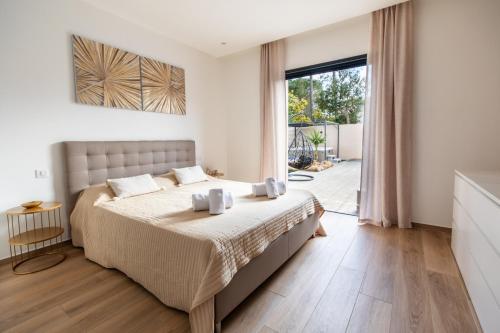 a bedroom with a bed and a large window at Superbe villa, piscine chauffée, jacuzzi in Lecci