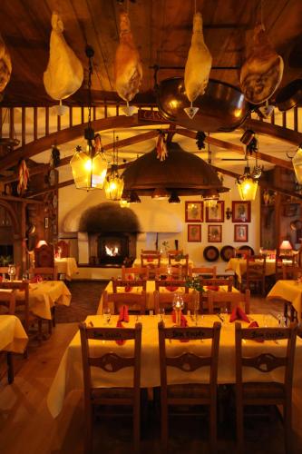 a restaurant with tables and chairs and a fireplace at 4-Sterne Erlebnishotel El Andaluz, Europa-Park Erlebnis-Resort in Rust