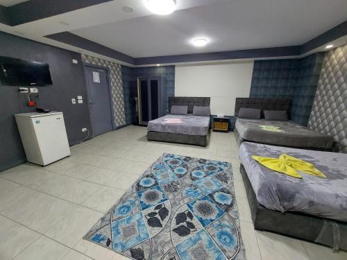 a hotel room with two beds and a television at Best Dreams Hotel in Cairo