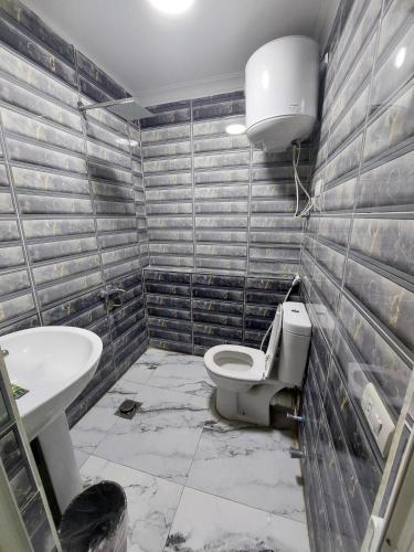 a bathroom with a toilet and a sink at Best Dreams Hotel in Cairo